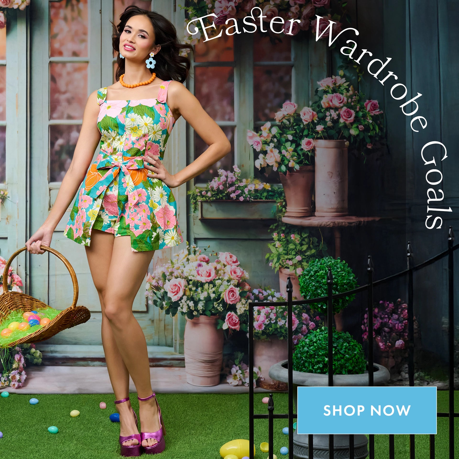 Woman in a floral dress standing in front of a decorated Easter setting with flowers and a basket.