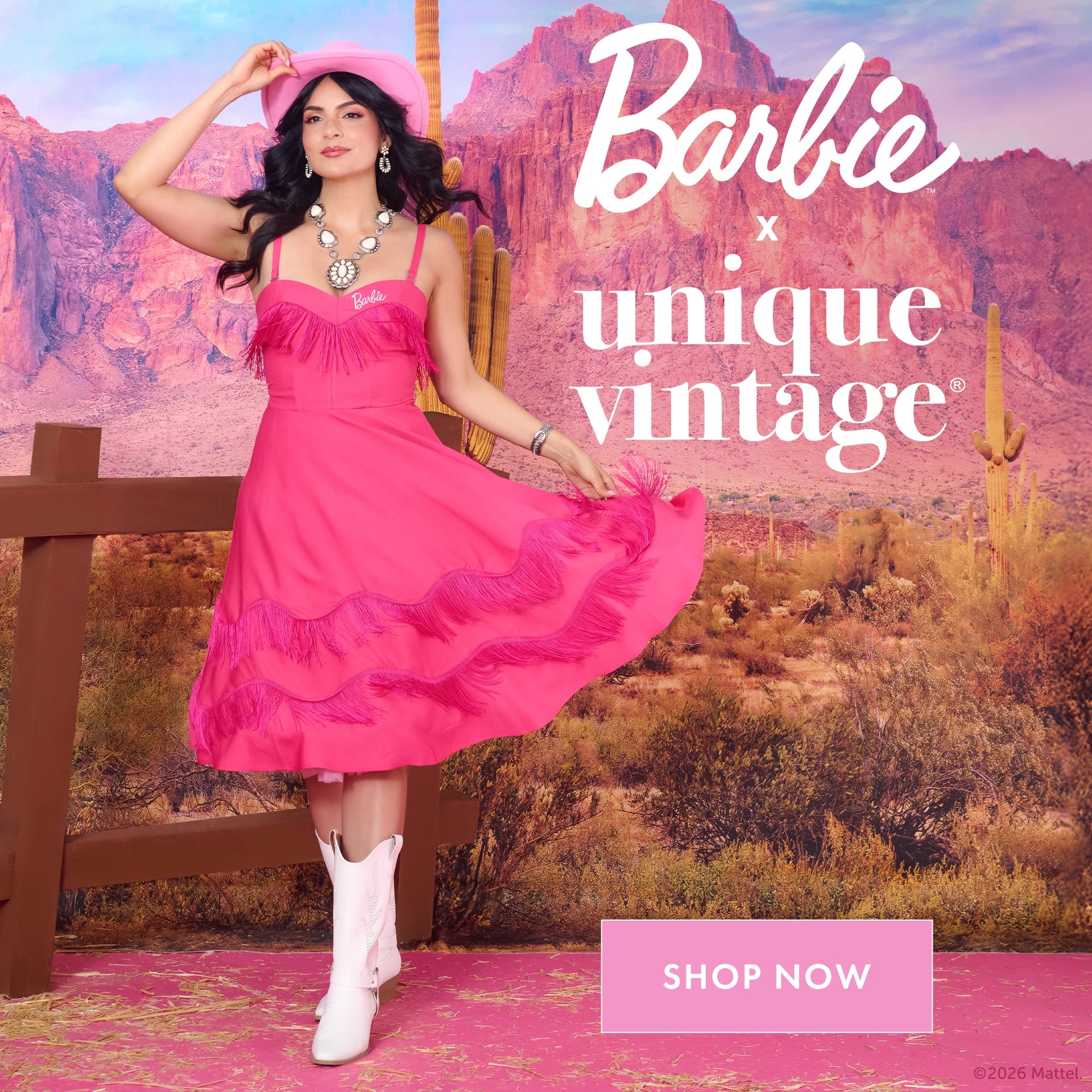 Woman in a pink dress with a desert landscape background, featuring Barbie x Unique Vintage branding.