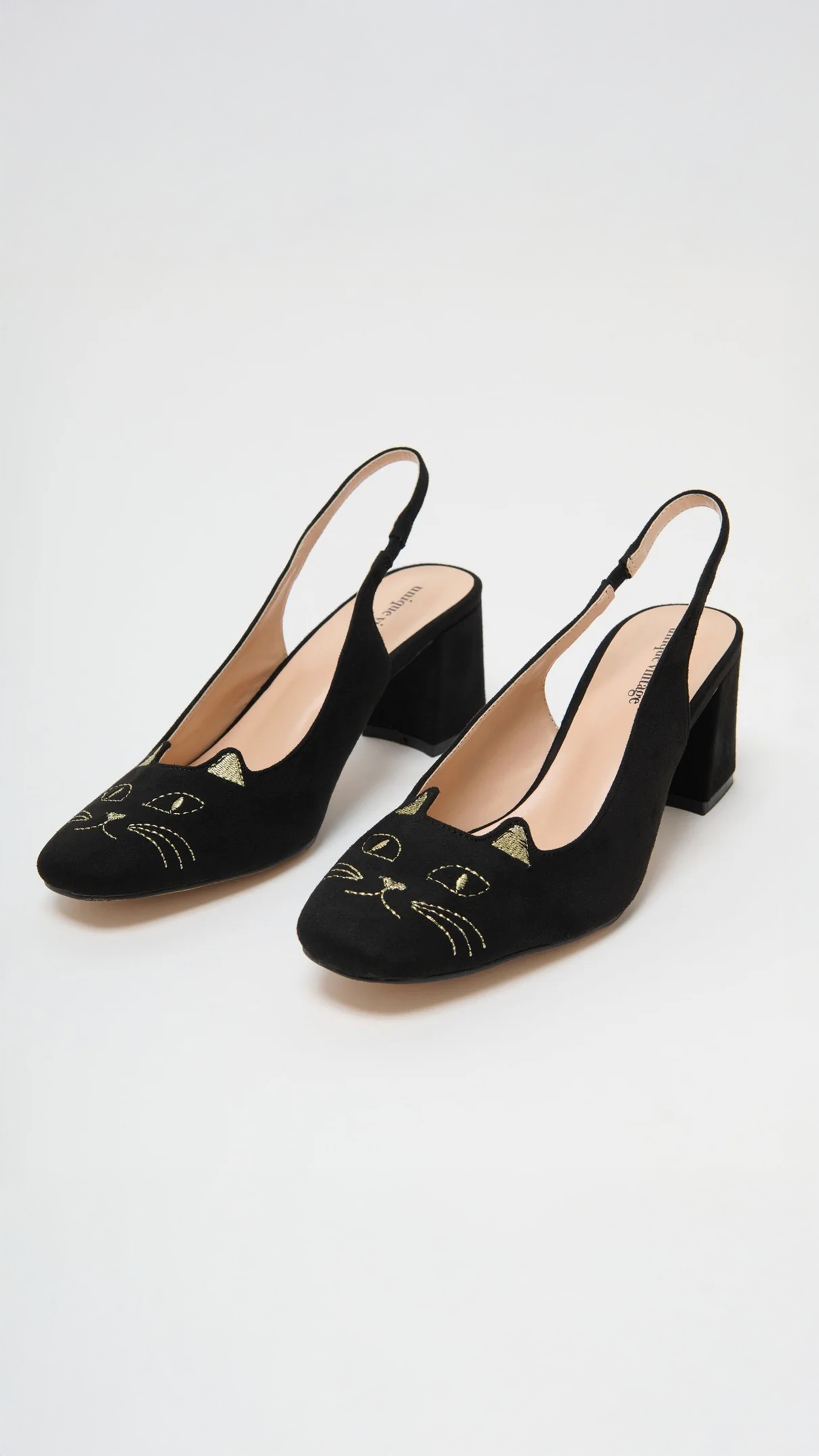 A pair of black slingback block-heel pumps with embroidered cat faces on the toe, shown on a light gray studio background.