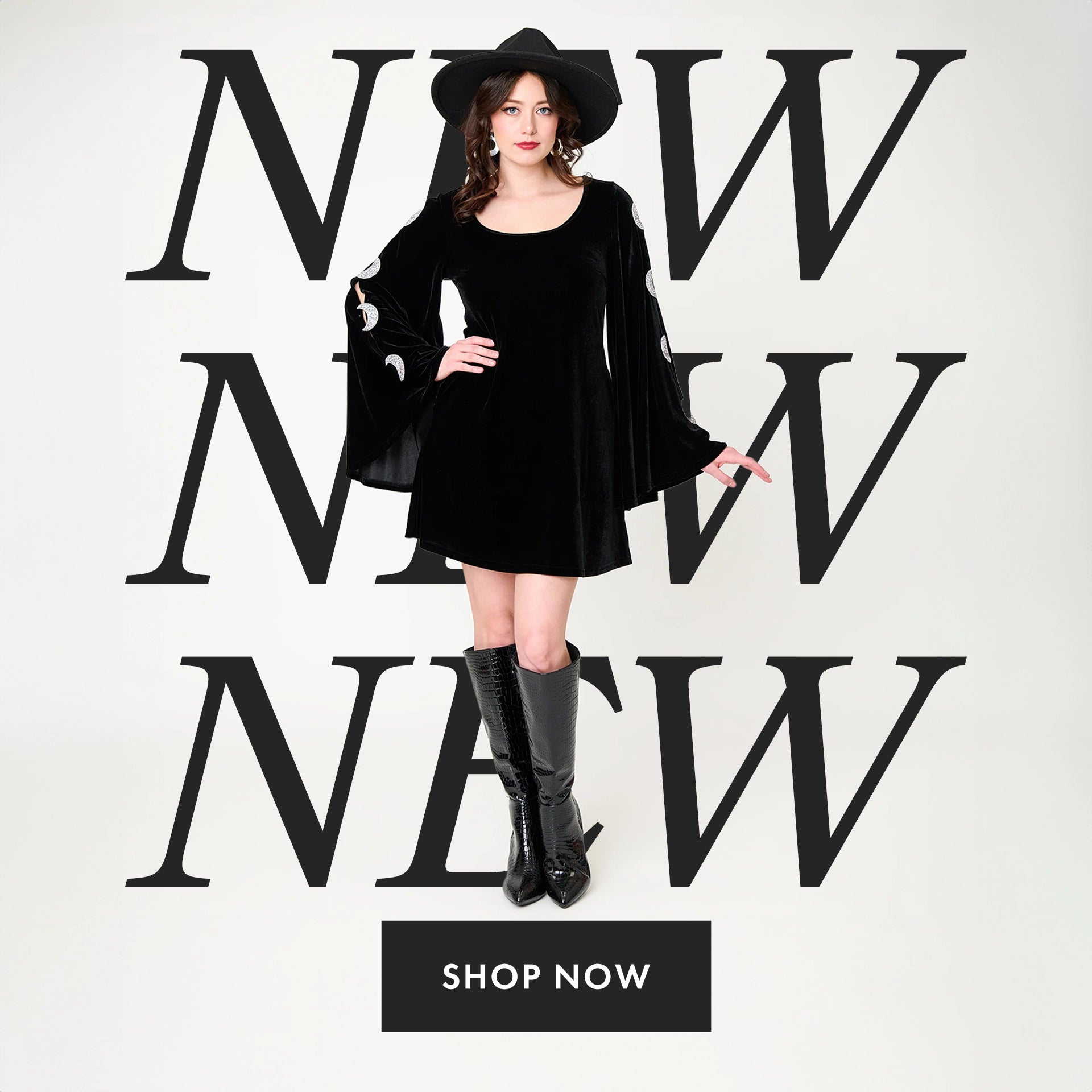 A woman models a black velvet long-sleeve mini dress with white polka-dot cuffs, a black wide-brim hat, and black knee-high boots against a white background with large black 'NEW' text and a 'SHOP NOW' button.
