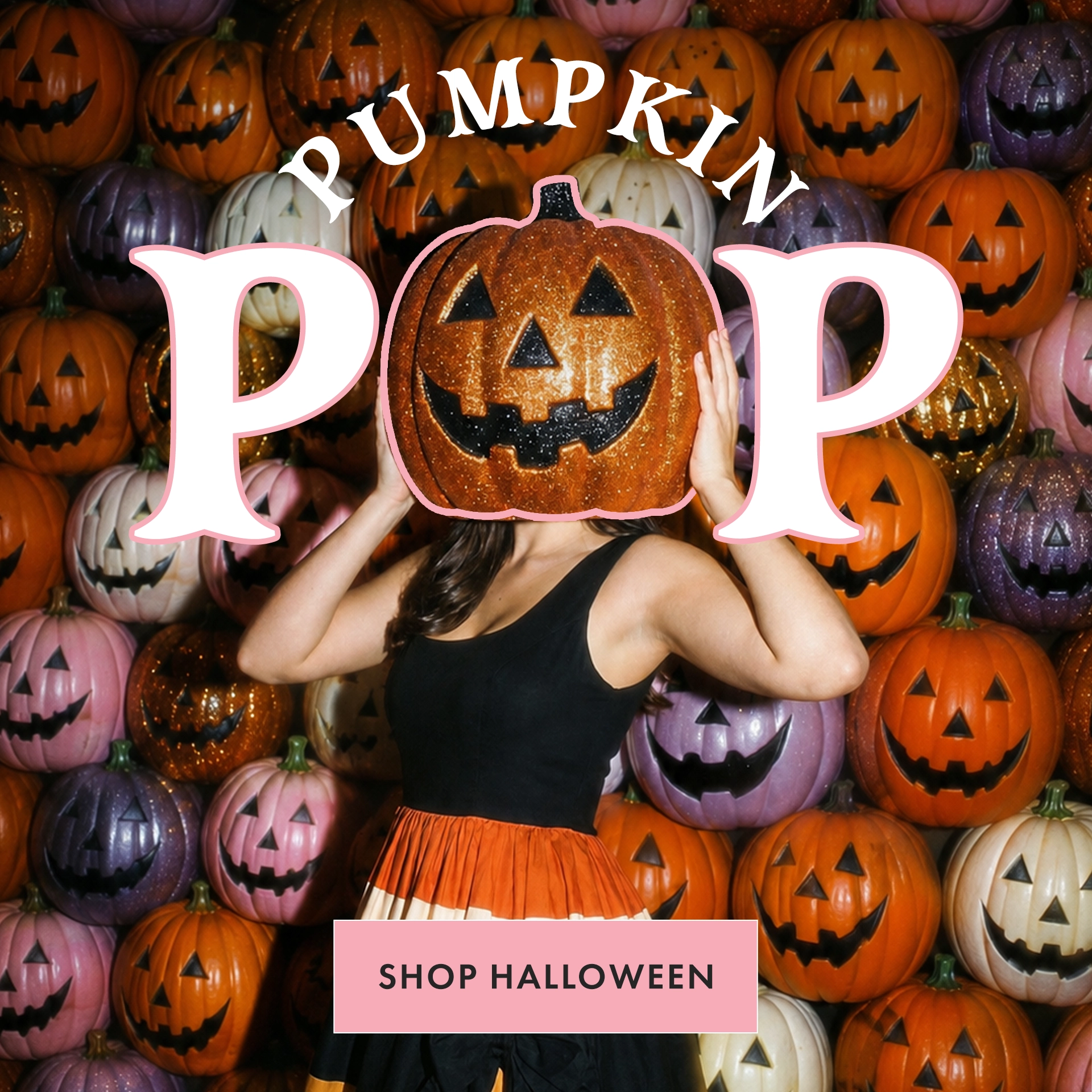 A woman in a black sleeveless top and orange pleated skirt stands in front of a wall of decorated pumpkins, holding a glittery jack-o'-lantern over her face. Large white text reads 'PUMPKIN POP' with a pink outline, and a pink label at the bottom says 'SHOP HALLOWEEN'.