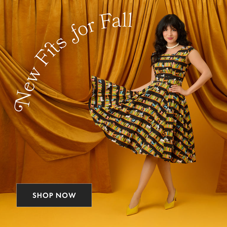 Woman in a patterned dress posing against an orange curtain with 'New Fits for Fall' text.