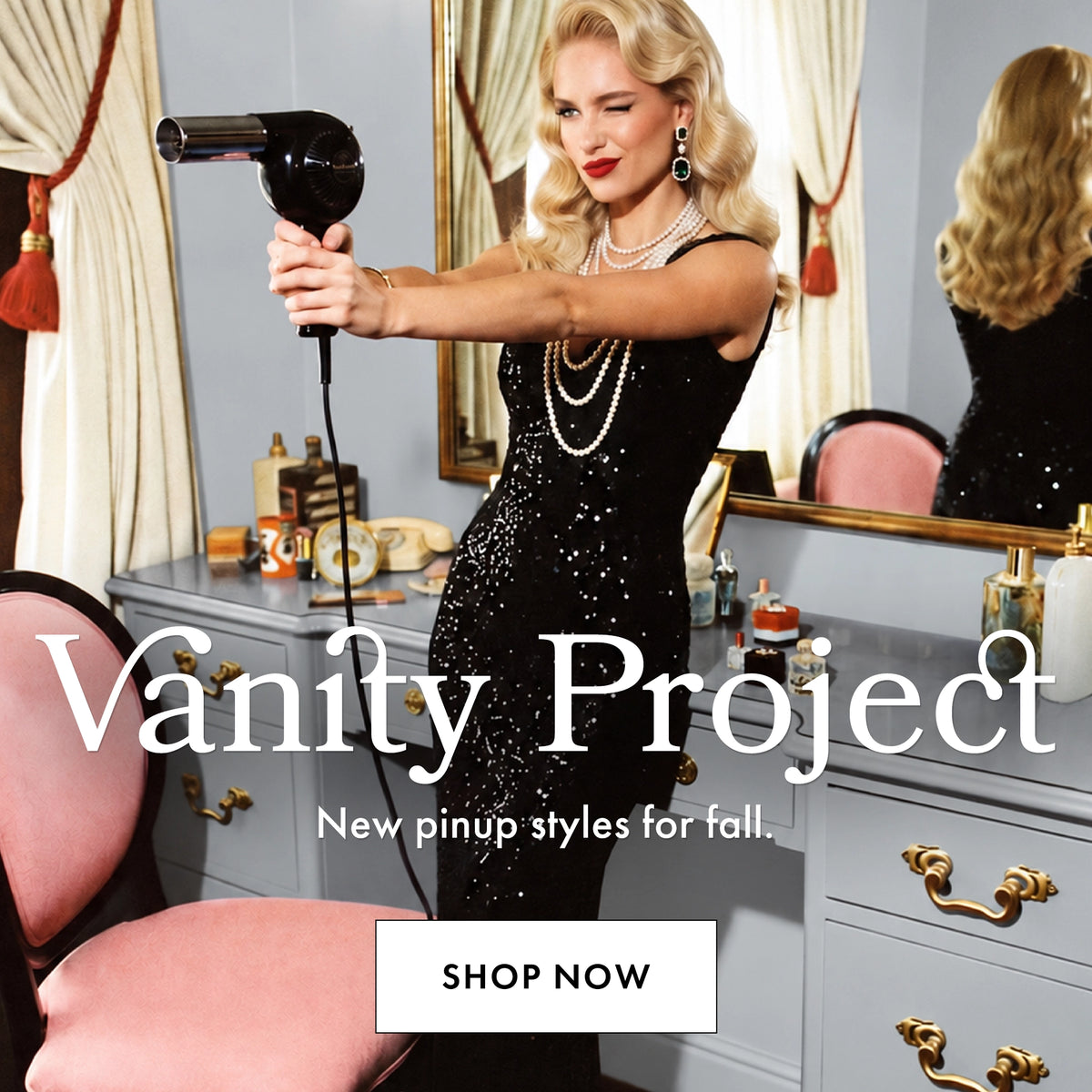 A woman in a black sequined dress stands in a vanity room holding a black hair dryer, with large text reading 'Vanity Project' and 'New pinup styles for fall.' and a 'SHOP NOW' button overlaid on the image.