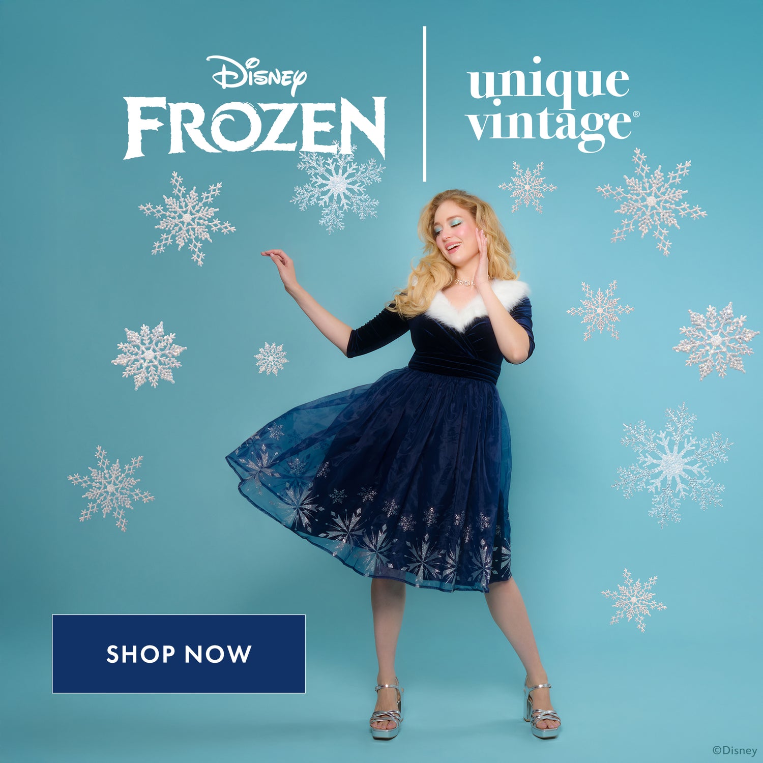 Woman in a blue dress with white fur trim against a blue background with snowflakes, featuring Disney Frozen and Unique Vintage logos.