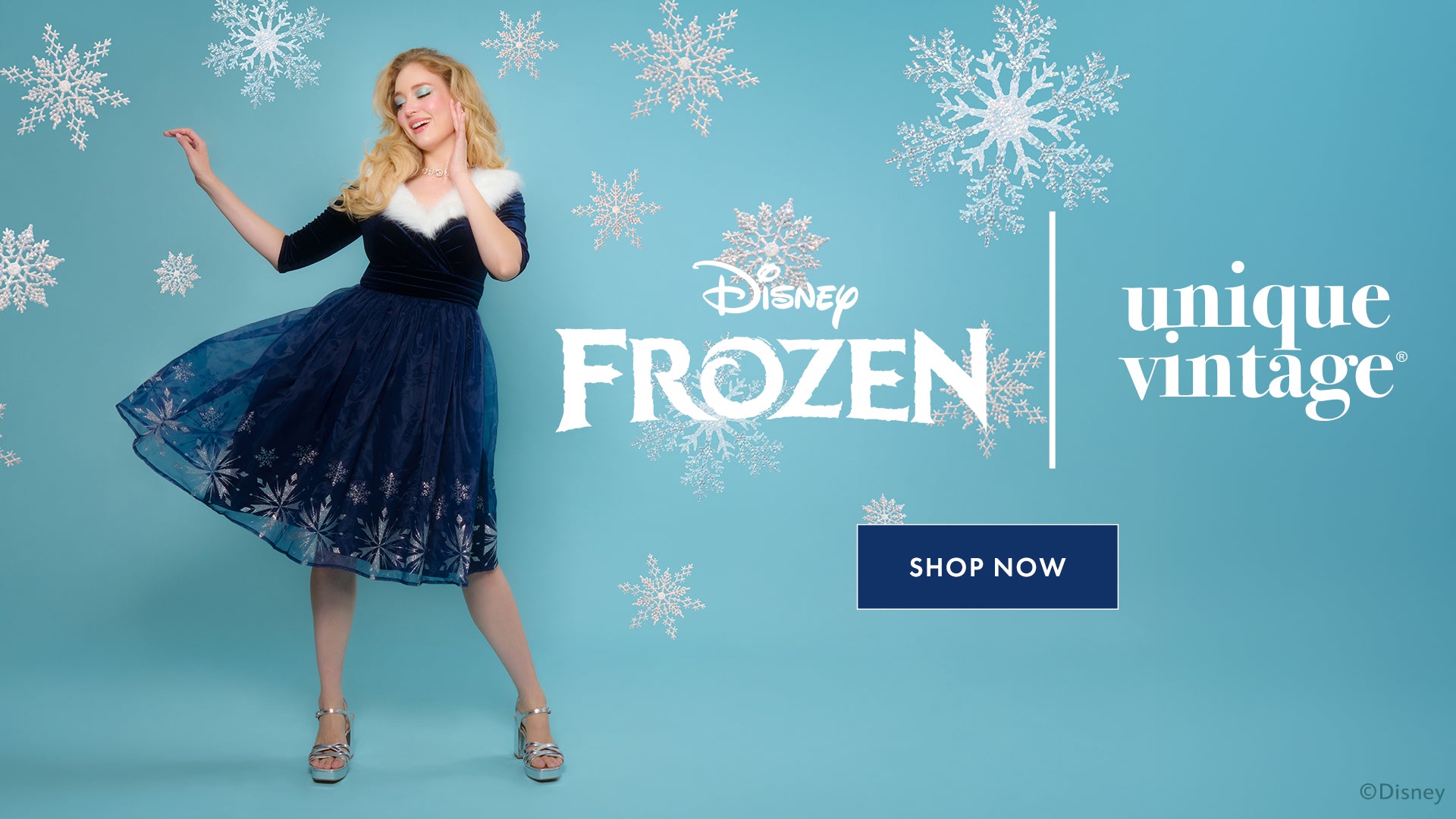 Woman in a blue dress with white fur trim against a blue background with snowflakes, featuring Disney Frozen and Unique Vintage logos.