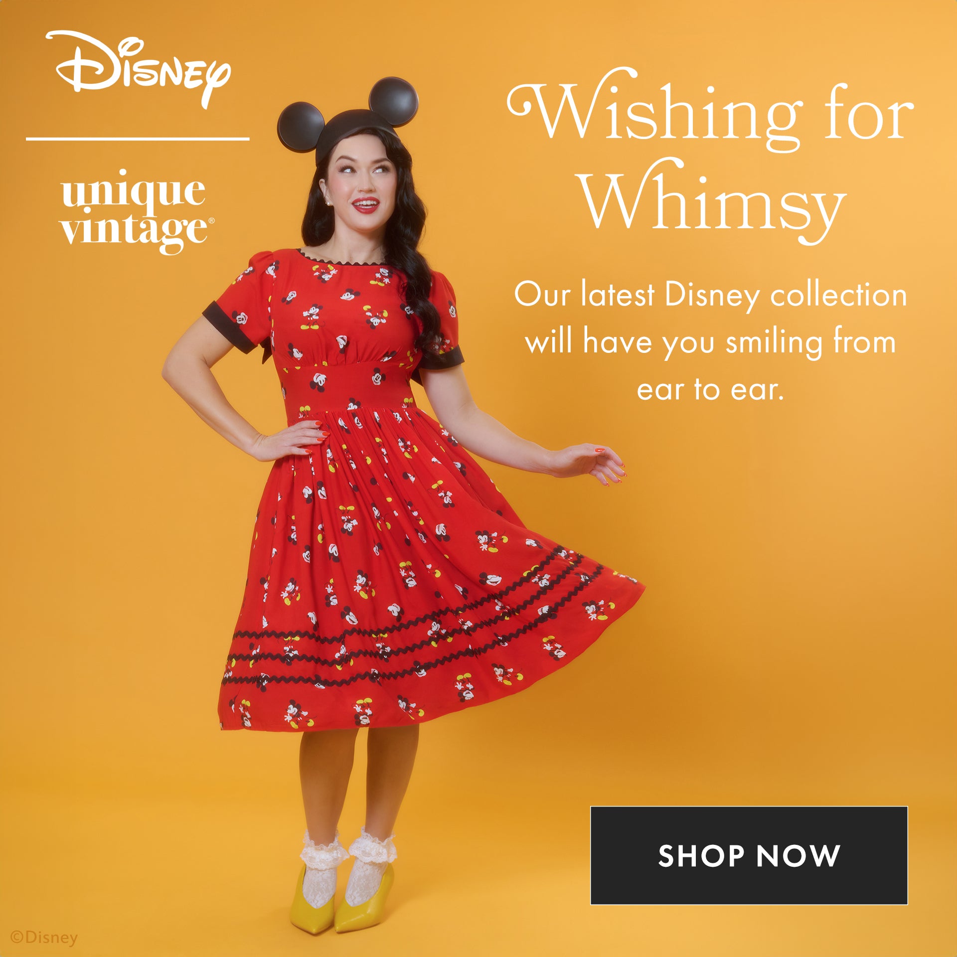 Woman in a red dress with character print on an orange background, featuring Disney branding.